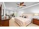 Spacious bedroom featuring a ceiling fan, neutral walls, carpet, and a cozy sitting area with desk at 7552 Hasentree Club Dr, Wake Forest, NC 27587