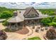 Overhead shot of clubhouse patio with tables, umbrellas, and stone architecture at 7552 Hasentree Club Dr, Wake Forest, NC 27587