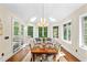 Bright dining room with large windows, skylights and table set for a dinner at 7552 Hasentree Club Dr, Wake Forest, NC 27587