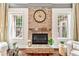 Close up of the stone fireplace with decor, and bright windows at 7552 Hasentree Club Dr, Wake Forest, NC 27587