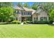 Charming two-story home with a well-manicured lawn and beautiful landscaping at 7552 Hasentree Club Dr, Wake Forest, NC 27587