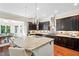 Gourmet kitchen showcasing granite countertops, stainless appliances, and stylish lighting at 7552 Hasentree Club Dr, Wake Forest, NC 27587