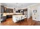 Gourmet kitchen featuring custom cabinetry, granite counters, and a center island at 7552 Hasentree Club Dr, Wake Forest, NC 27587