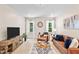 Inviting living room featuring a brown leather sofa set, media console and contemporary decor at 7552 Hasentree Club Dr, Wake Forest, NC 27587