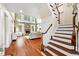 Cozy living room with a stone fireplace, large windows, and comfortable seating at 7552 Hasentree Club Dr, Wake Forest, NC 27587
