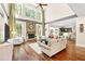 Spacious living room with a stone fireplace, tall windows, and open layout at 7552 Hasentree Club Dr, Wake Forest, NC 27587