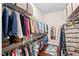 A walk-in closet with built-in shelving and hanging rods for ample storage at 7552 Hasentree Club Dr, Wake Forest, NC 27587