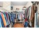 Organized walk-in closet with shelving, clothing rods, and hardwood floors offering ample storage space at 7552 Hasentree Club Dr, Wake Forest, NC 27587