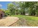 Lush backyard with mature trees, a shed, and ample green space for outdoor activities and relaxation at 780 Leslie Campbell Ave, Lillington, NC 27546