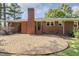 Charming brick home has a patio with gravel for entertaining in the backyard surrounded by beautiful greenery at 780 Leslie Campbell Ave, Lillington, NC 27546
