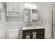 Well-lit bathroom featuring a modern vanity, sink, toilet, and a washer-dryer unit for convenience at 780 Leslie Campbell Ave, Lillington, NC 27546