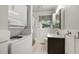 Bathroom with modern stacked washer and dryer along with a vanity, sink, and updated fixtures at 780 Leslie Campbell Ave, Lillington, NC 27546
