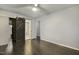 Bedroom with hardwood floors features a sliding barn door that adds rustic charm to the space at 780 Leslie Campbell Ave, Lillington, NC 27546