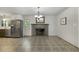 Dining room with decorative tile flooring, featuring stainless steel appliances and a charming fireplace at 780 Leslie Campbell Ave, Lillington, NC 27546