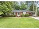 Charming single-story brick home with well-maintained landscaping and a convenient attached carport at 780 Leslie Campbell Ave, Lillington, NC 27546