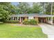 Charming single-story brick home with well-maintained landscaping and a convenient attached carport at 780 Leslie Campbell Ave, Lillington, NC 27546