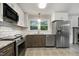 Kitchen showcases updated appliances, white subway tile, and generous counter space at 780 Leslie Campbell Ave, Lillington, NC 27546