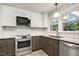 Kitchen features updated stainless steel appliances and lots of natural light at 780 Leslie Campbell Ave, Lillington, NC 27546