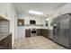 Kitchen features stainless steel appliances, modern cabinetry, and patterned floors at 780 Leslie Campbell Ave, Lillington, NC 27546