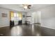Bright living room featuring hardwood floors, neutral walls, and large window with stylish curtains at 780 Leslie Campbell Ave, Lillington, NC 27546