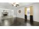 Spacious living room with hardwood floors, view of fireplace, and natural light from large window at 780 Leslie Campbell Ave, Lillington, NC 27546