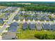 An aerial view displays a neighborhood featuring well-maintained homes with manicured lawns in a suburban setting at 797 S Wilma St, Angier, NC 27501