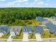 An aerial view showcases a neighborhood with lush trees, a pond, and well-maintained homes with manicured lawns at 797 S Wilma St, Angier, NC 27501