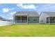 Expansive backyard featuring a well-maintained lawn and a view of the home's exterior at 797 S Wilma St, Angier, NC 27501
