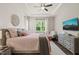 Bedroom features a tray ceiling, wood accent wall, and neutral furnishings at 797 S Wilma St, Angier, NC 27501