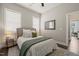Bedroom with neutral decor, a queen-size bed, and a framed mirror on the wall at 797 S Wilma St, Angier, NC 27501