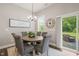Elegant dining area with stylish chandelier and sliding glass door to an outdoor space at 797 S Wilma St, Angier, NC 27501
