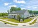 A beautifully landscaped clubhouse shows meticulous care with manicured greenery surrounding a gray colored building at 797 S Wilma St, Angier, NC 27501