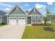 Charming home featuring a two-car garage, manicured lawn, and tasteful landscaping at 797 S Wilma St, Angier, NC 27501