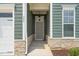 Charming front entrance with stone accents, welcoming signage, and a well-lit porch at 797 S Wilma St, Angier, NC 27501