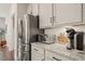 A kitchen featuring stainless steel appliances, granite counters, and white cabinets at 797 S Wilma St, Angier, NC 27501
