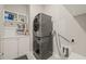 Laundry room featuring a gray washer and dryer with white storage cabinets at 797 S Wilma St, Angier, NC 27501