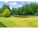Scenic view of a serene pond surrounded by lush greenery in the backyard at 797 S Wilma St, Angier, NC 27501