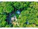 Aerial view of the property surrounded by lush, mature trees, offering privacy and natural beauty at 838 Joyner Ct, Wake Forest, NC 27587