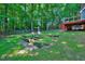 The backyard shows a fire pit and mature shade trees offering a tranquil outdoor space at 838 Joyner Ct, Wake Forest, NC 27587