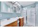 Bathroom featuring double sinks, a shower, and blue accent walls at 838 Joyner Ct, Wake Forest, NC 27587