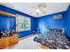 Bedroom with blue walls, a ceiling fan, and a bed with dinosaur sheets at 838 Joyner Ct, Wake Forest, NC 27587