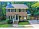 Charming brick home with symmetrical windows, black shutters, and manicured front yard at 838 Joyner Ct, Wake Forest, NC 27587