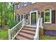 Close up of a brick two-story house with a set of brick steps leading up to the front door at 838 Joyner Ct, Wake Forest, NC 27587
