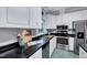 Bright kitchen with stainless steel appliances and black granite countertops at 838 Joyner Ct, Wake Forest, NC 27587