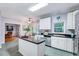 Bright kitchen with stainless steel appliances, island, and a cozy breakfast nook at 838 Joyner Ct, Wake Forest, NC 27587