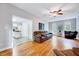 Bright living room with hardwood floors, leather couches, and a view into the kitchen at 838 Joyner Ct, Wake Forest, NC 27587