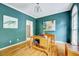 Inviting home office with hardwood floors, natural light, and blue walls at 838 Joyner Ct, Wake Forest, NC 27587
