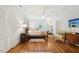 Spacious bedroom with hardwood floors, a patterned rug, and a large window at 1004 E Willowbrook Dr, Burlington, NC 27215