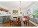 Dining room featuring a chandelier, brick fireplace, and built in cabinets at 1004 E Willowbrook Dr, Burlington, NC 27215