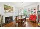 Dining room featuring a brick fireplace, built in cabinets and a chandelier at 1004 E Willowbrook Dr, Burlington, NC 27215